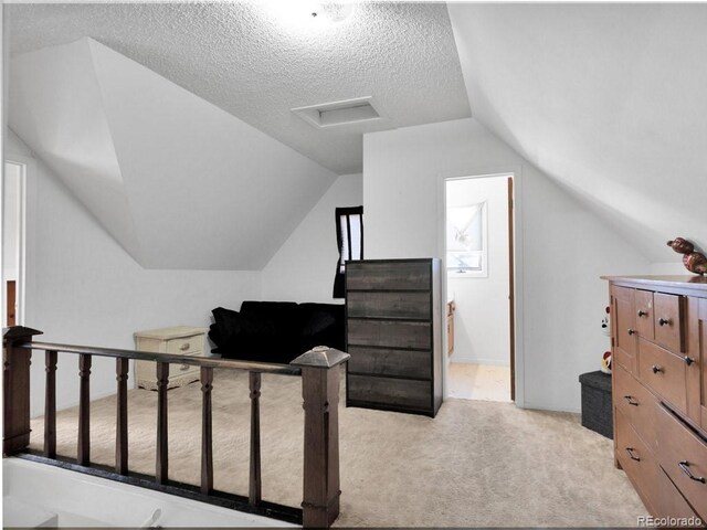 317 Adams Ave, Akron, CO 80720 - carpeted bedroom featuring vaulted ceiling and a textured ceiling