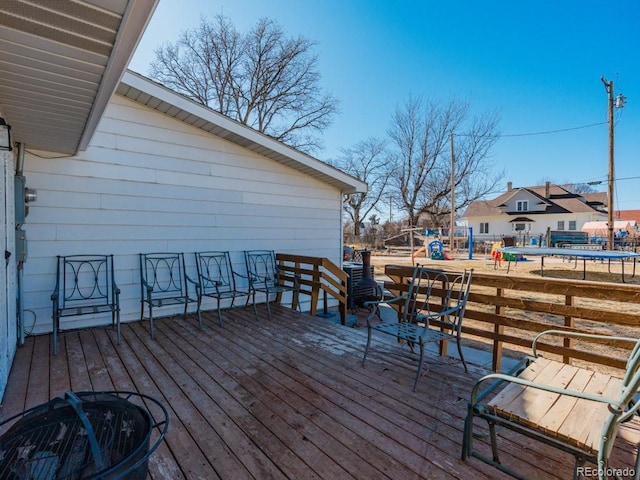 317 Adams Ave, Akron, CO 80720 - wooden terrace with a playground and a trampoline