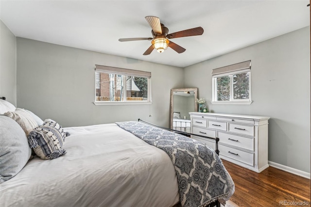 bedroom with multiple windows, ceiling fan, and dark hardwood / wood-style floors