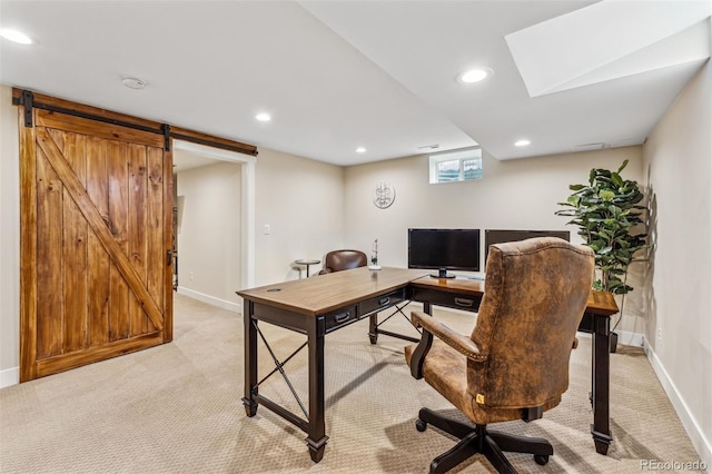 office space with a barn door and light colored carpet