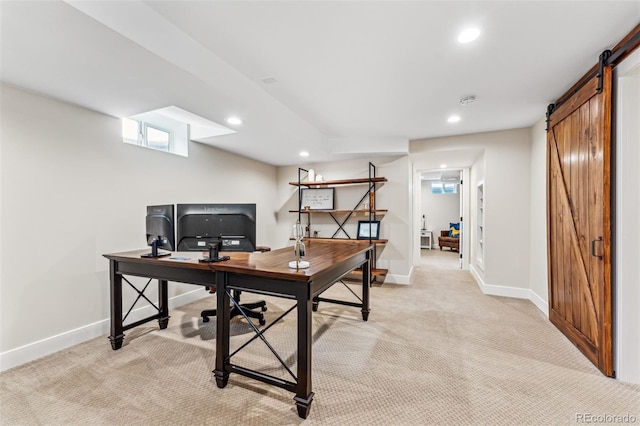 office area with a barn door and light colored carpet