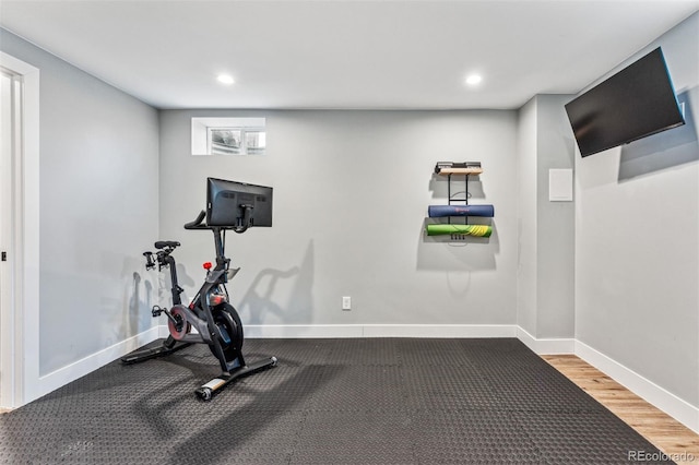 workout area with hardwood / wood-style floors