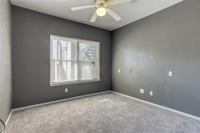 empty room with ceiling fan and carpet