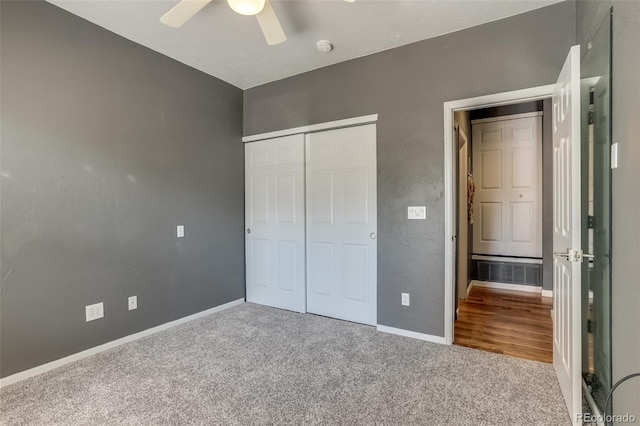 unfurnished bedroom featuring carpet flooring, ceiling fan, and a closet