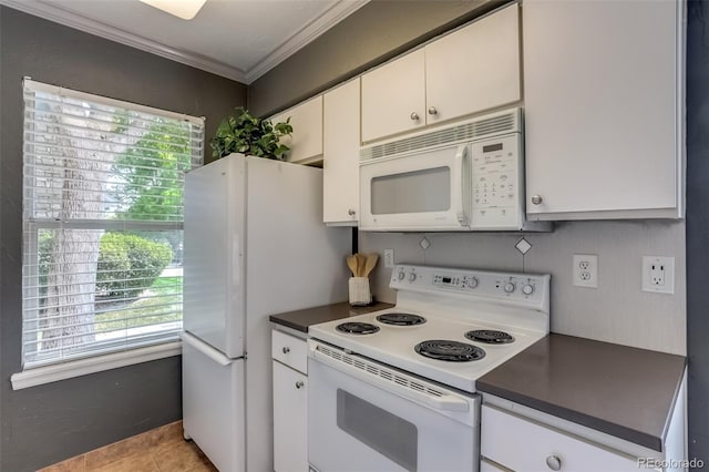 kitchen with crown molding, light tile patterned floors, white cabinets, and white appliances