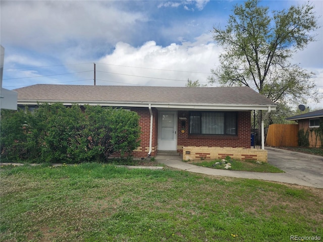 4730 Carr St, Wheat Ridge, CO 80033 - ranch-style home with roof with shingles, fence, a front lawn, and brick siding