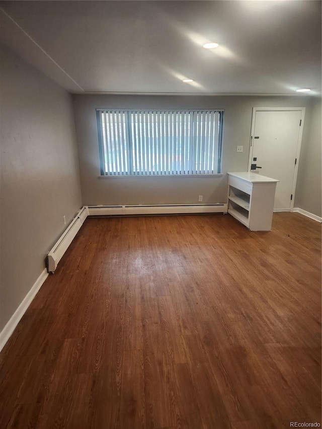 4730 Carr St, Wheat Ridge, CO 80033 - spare room with a baseboard radiator, baseboards, and dark wood finished floors