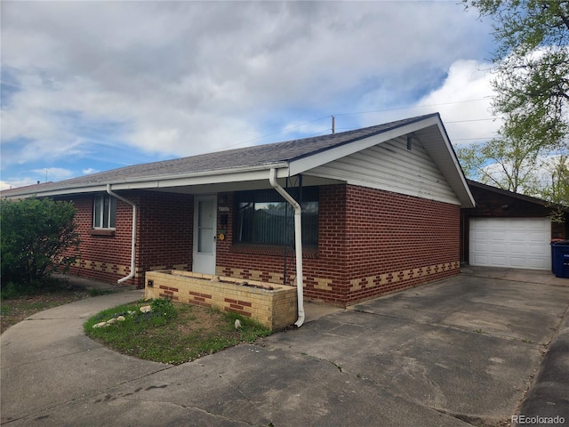 4730 Carr St, Wheat Ridge, CO 80033 - single story home with a porch, concrete driveway, a garage, and brick siding