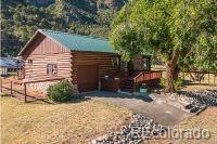 24938 US Highway 50, Cotopaxi, CO 81223 - view of home's exterior featuring log siding, a wooden deck, and an outdoor structure