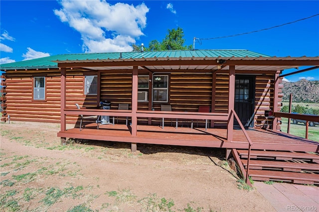 24938 US Highway 50, Cotopaxi, CO 81223 - view of front of house with a metal roof, log exterior, and a deck