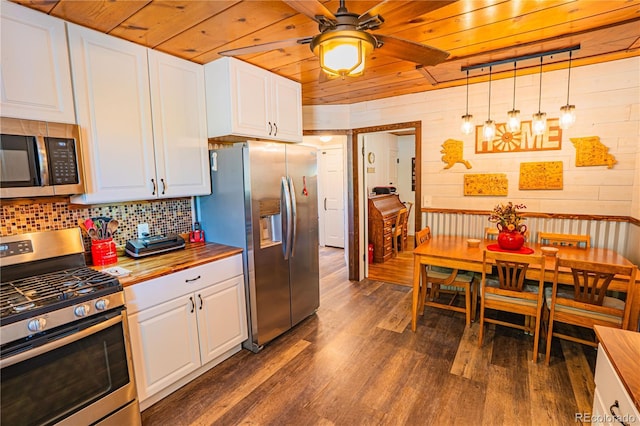 24938 US Highway 50, Cotopaxi, CO 81223 - kitchen with appliances with stainless steel finishes, wood ceiling, dark wood-type flooring, white cabinets, and butcher block countertops
