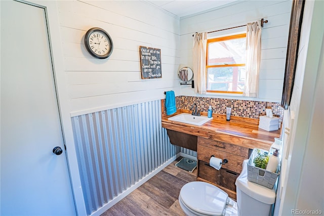 24938 US Highway 50, Cotopaxi, CO 81223 - bathroom featuring wood finished floors, ornamental molding, wood walls, and tasteful backsplash