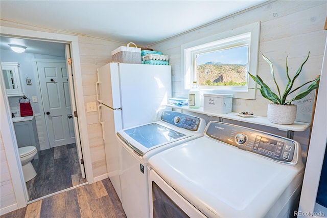 24938 US Highway 50, Cotopaxi, CO 81223 - washroom featuring wood finished floors, washer and clothes dryer, and wooden walls