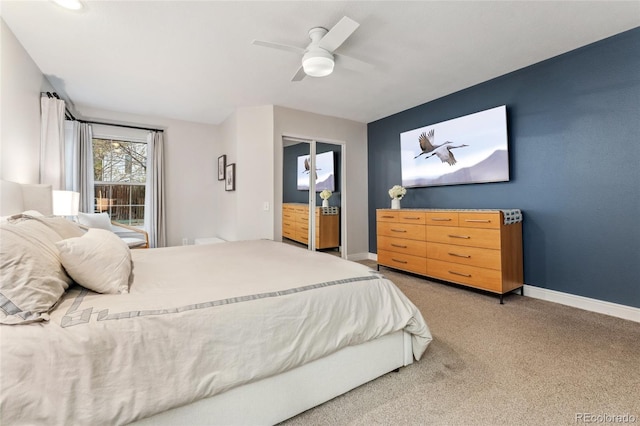 bedroom with light carpet, baseboards, and ceiling fan