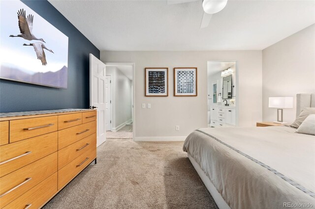 bedroom with a sink, light carpet, baseboards, and a ceiling fan