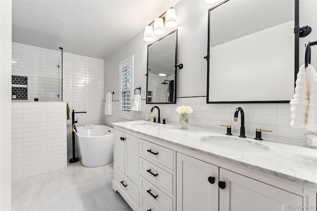 full bath with a sink, double vanity, tile walls, and tile patterned floors
