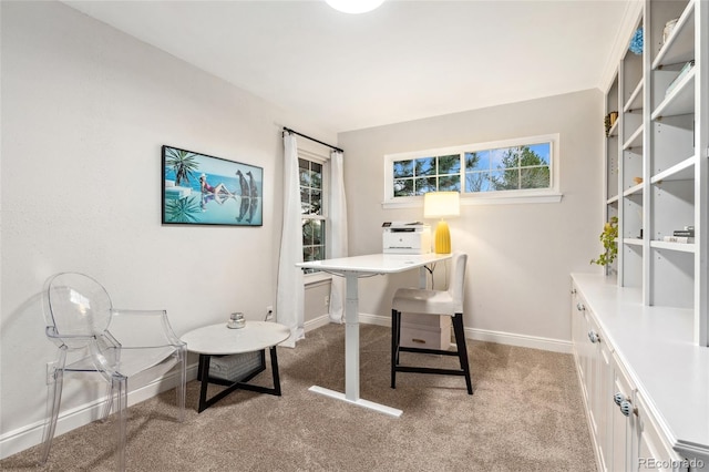 home office with baseboards and light carpet