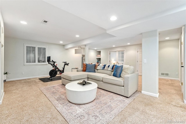 carpeted living area featuring baseboards, visible vents, and recessed lighting