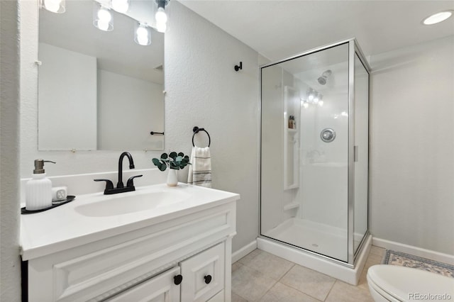full bathroom with toilet, a stall shower, tile patterned floors, baseboards, and vanity