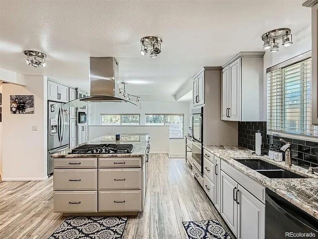 9910 Ammons Cir, Westminster, CO 80021 - kitchen with a sink, appliances with stainless steel finishes, island exhaust hood, backsplash, and a kitchen island