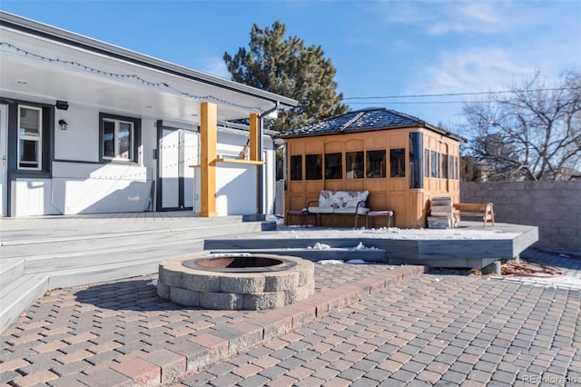 9910 Ammons Cir, Westminster, CO 80021 - view of patio with fence, a fire pit, and an outdoor structure