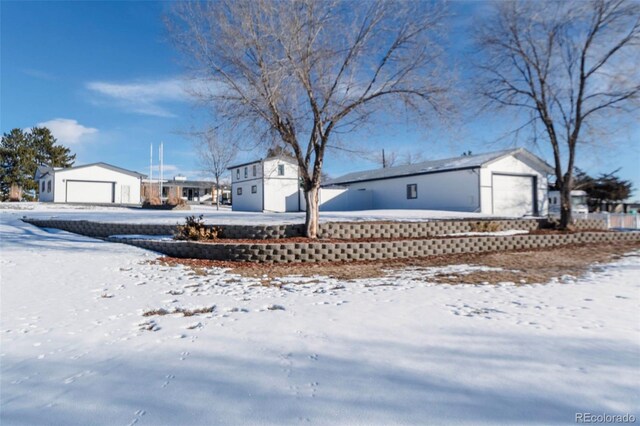 9910 Ammons Cir, Westminster, CO 80021 - yard covered in snow with an outbuilding and a detached garage