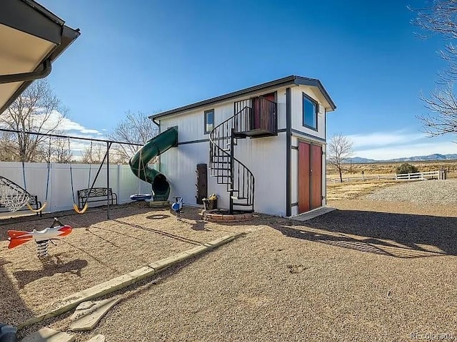 9910 Ammons Cir, Westminster, CO 80021 - view of outbuilding featuring a mountain view, fence, and stairway