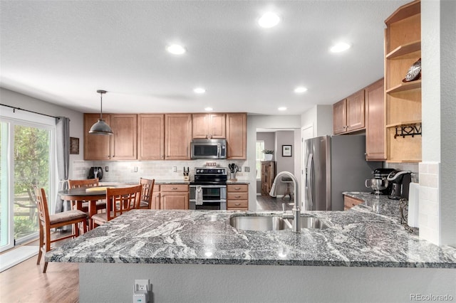7234 S Kellerman Way, Aurora, CO 80016 - kitchen featuring stainless steel appliances, a sink, open shelves, dark stone countertops, and recessed lighting