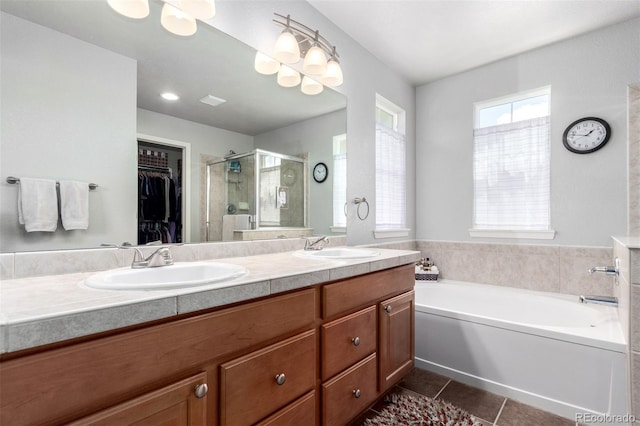 7234 S Kellerman Way, Aurora, CO 80016 - bathroom with tile patterned flooring, a shower stall, double vanity, a walk in closet, and a garden tub