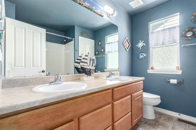 7234 S Kellerman Way, Aurora, CO 80016 - full bath with baseboards, double vanity, toilet, tile patterned floors, and a shower