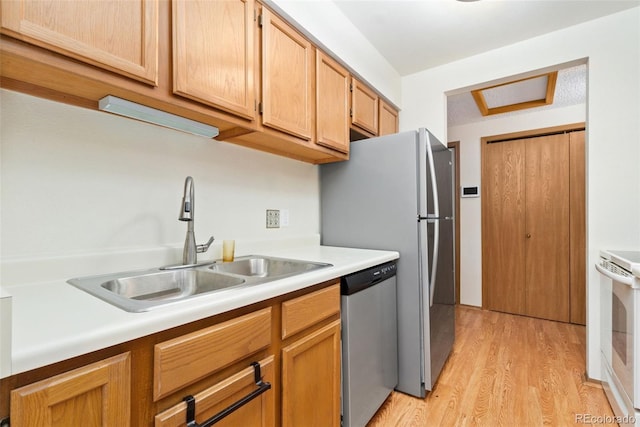 8404 Everett Way Unit A, Arvada, CO 80005 - kitchen with stainless steel dishwasher, stove, light wood-type flooring, and light countertops
