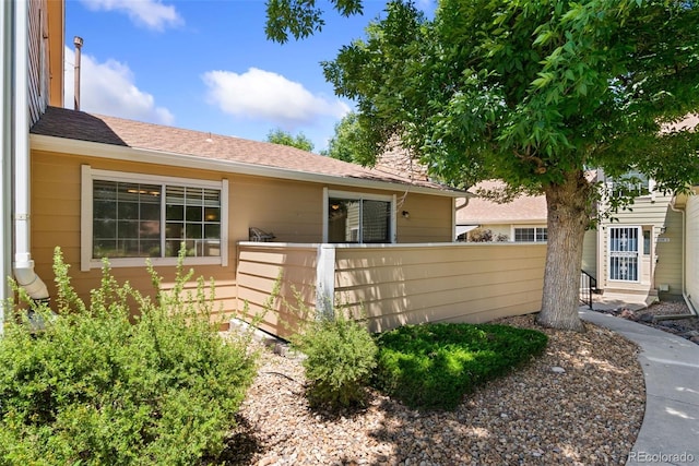 8404 Everett Way Unit A, Arvada, CO 80005 - view of front of house with a chimney and a shingled roof