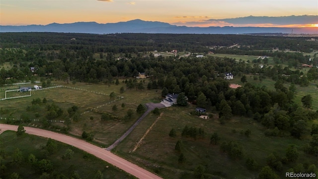 aerial view at dusk featuring a mountain view