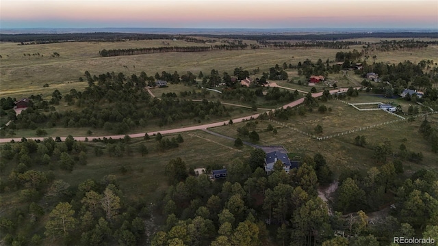 aerial view at dusk featuring a rural view