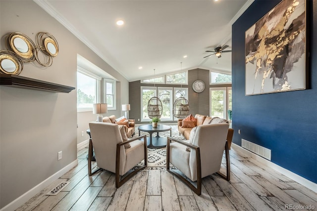 living room featuring crown molding, light hardwood / wood-style floors, vaulted ceiling, and ceiling fan