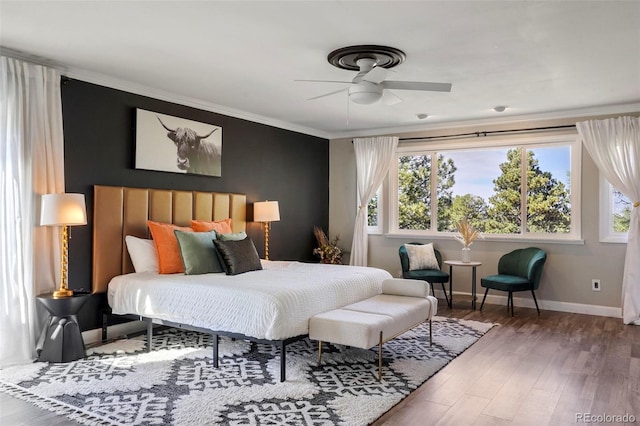 bedroom with wood-type flooring, ceiling fan, and crown molding