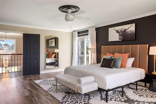 bedroom featuring ceiling fan, dark hardwood / wood-style floors, and multiple windows