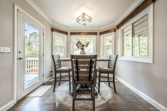 dining space with plenty of natural light, dark wood-type flooring, and crown molding