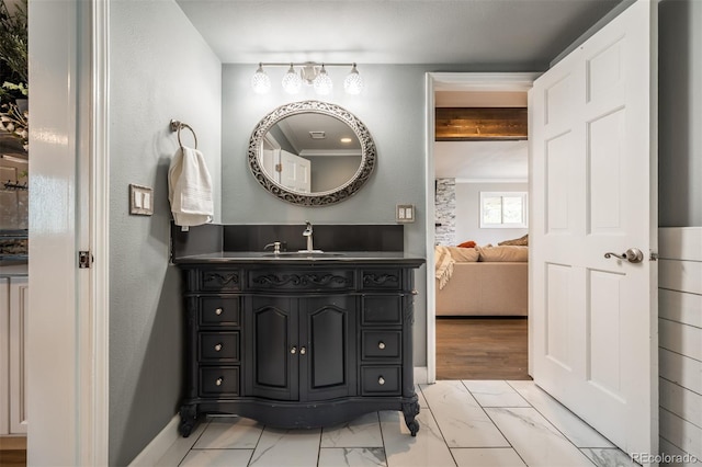 bathroom with beamed ceiling and vanity