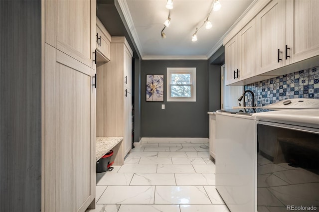 laundry room with cabinets, independent washer and dryer, and ornamental molding