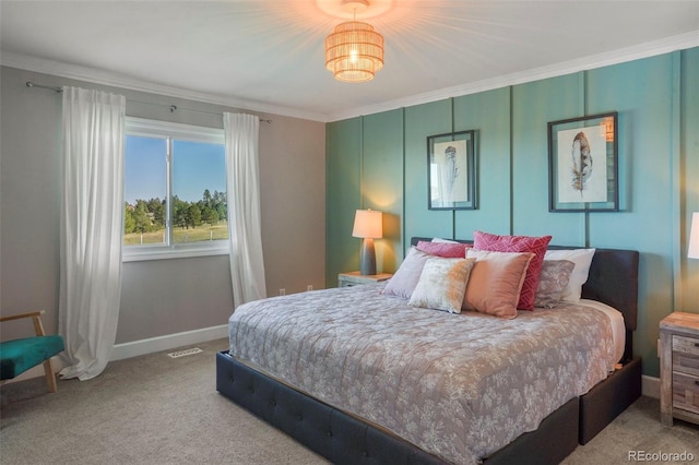 bedroom with crown molding and carpet flooring