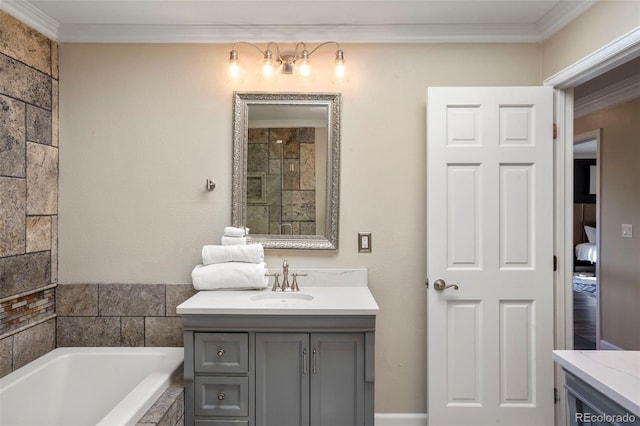 bathroom with tiled tub, vanity, and crown molding