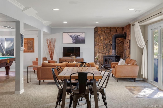 carpeted dining room featuring ornamental molding, a wood stove, and billiards