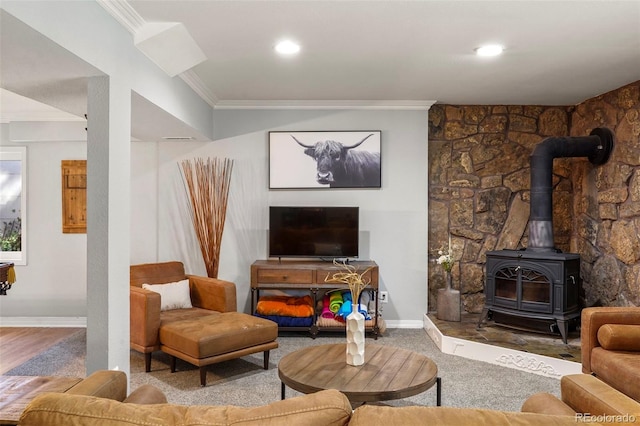 living room featuring a wood stove, hardwood / wood-style flooring, and crown molding