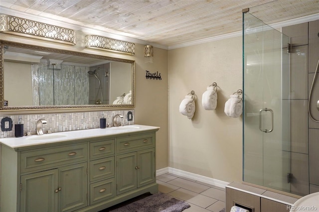 bathroom featuring a shower with shower door, backsplash, vanity, crown molding, and tile patterned flooring