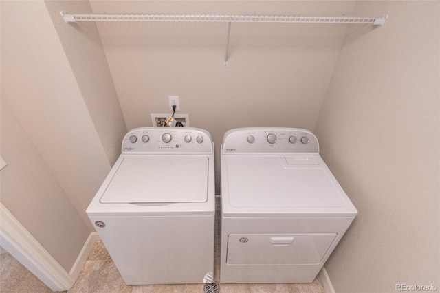 clothes washing area with washer and clothes dryer