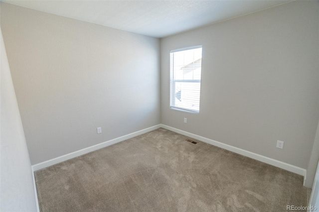 empty room featuring light carpet