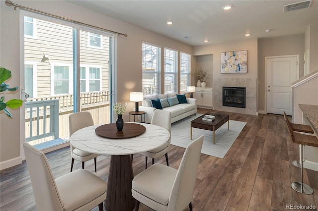 living room with dark hardwood / wood-style floors and a fireplace