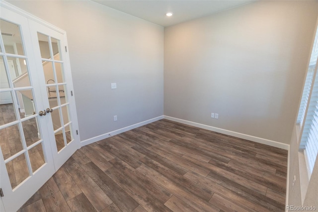 unfurnished room with french doors and dark wood-type flooring