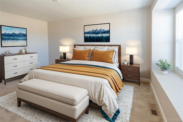 bedroom featuring light carpet